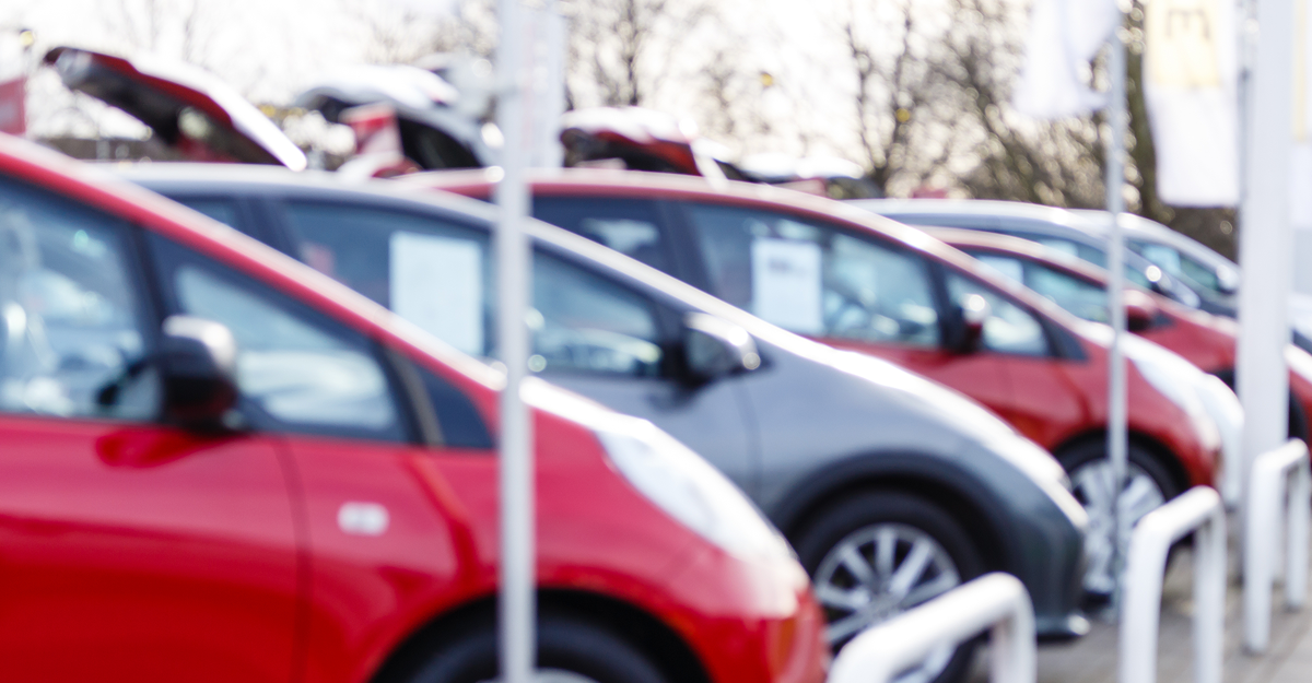 Used vehicles lined up at a Quebec dealership in the fall