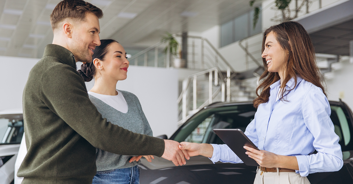 Customer finalizing a used vehicle purchase at a dealership