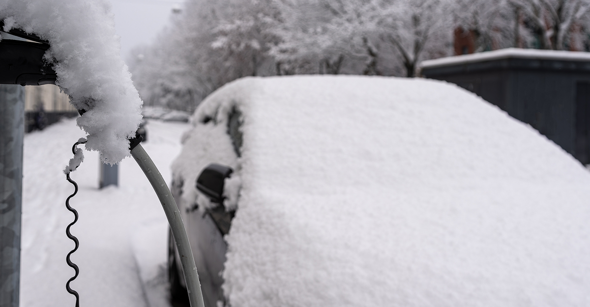 Electric vehicle driving on a snowy road in Quebec