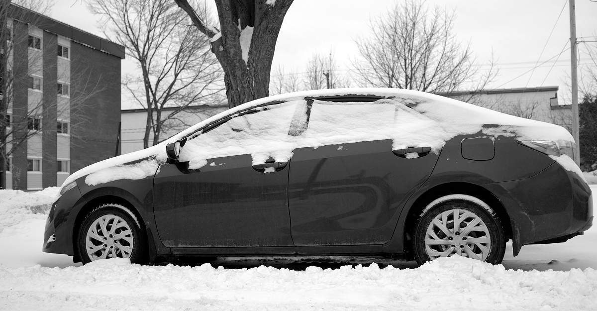 Used vehicle covered in snow on a winter morning in Quebec