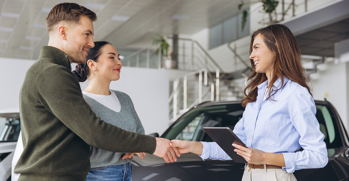 Customer finalizing the purchase of a used vehicle at a dealership